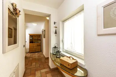 a hallway with a glass table with a suitcase on it at Valle Filippo in Canazei