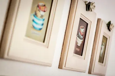 a group of framed pictures on a wall at Valle Filippo in Canazei