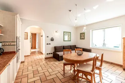 a living room with a table and a couch at Valle Filippo in Canazei