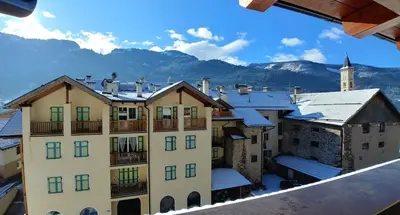 a view of a building with snow covered roofs at Trilocale mansardato nel cuore della Val Di Fiemme in Ziano di Fiemme