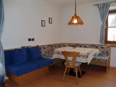 a living room with a blue couch and a table at Appartement Gandler in Valdaora