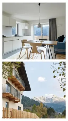 a kitchen and dining room with a view of mountains at Casa Lies - Apartments in Nova Ponente