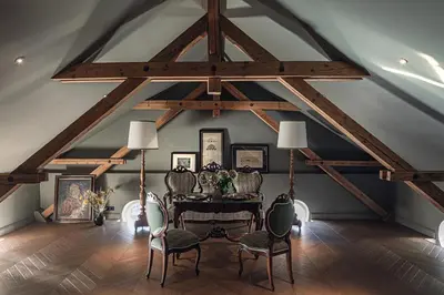 a dining room with a table and chairs in a attic at Hotel Elephant in Bressanone