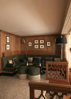 a living room with a green couch and a table at Hotel Elephant in Bressanone