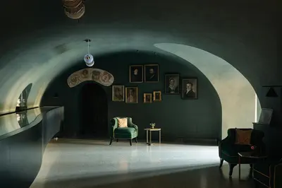 a dark room with a chair and a table at Hotel Elephant in Bressanone