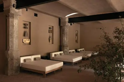 a room with four beds and a plant at Hotel Elephant in Bressanone