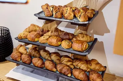 a bunch of loaves of bread and pastries on shelves at Wohlfühlhotel Mei Auszeit in Plaus