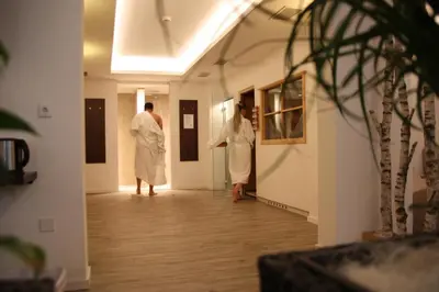 two men in white robes standing in a hallway at Wohlfühlhotel Mei Auszeit in Plaus