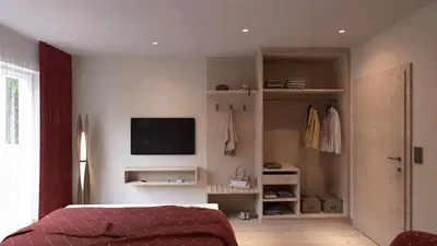 a bedroom with a bed and a tv on the wall at Wohlfühlhotel Mei Auszeit in Plaus
