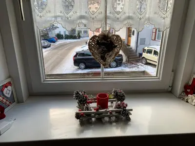 a window with a christmas wreath and a santa sleigh in front at Cèsa Viosadea in Campitello di Fassa