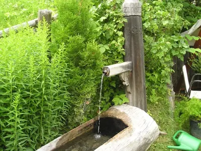 a wooden sink with a water fountain at Haus Tasser in San Lorenzo di Sebato