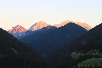 a view of a mountain range at sunset at Haus Tasser in San Lorenzo di Sebato