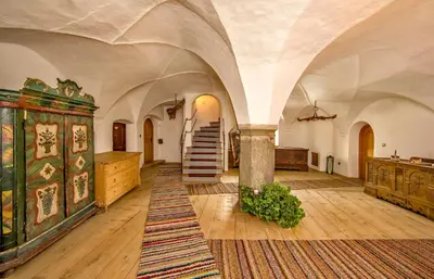 a large room with a staircase in a building at Krüglwirt in San Lorenzo di Sebato
