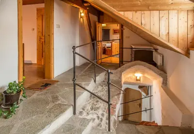 an attic staircase in a house with a igloo at Krüglwirt in San Lorenzo di Sebato