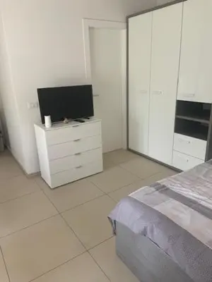 a bedroom with a bed and a tv on a dresser at Obsthof Klotz in Frangarto