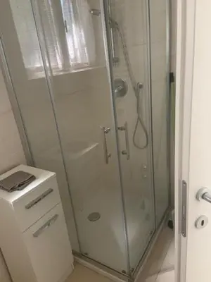 a bathroom with a shower with a glass shower stall at Obsthof Klotz in Frangarto