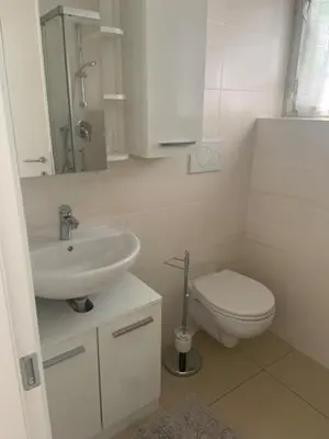 a white bathroom with a sink and a toilet at Obsthof Klotz in Frangarto