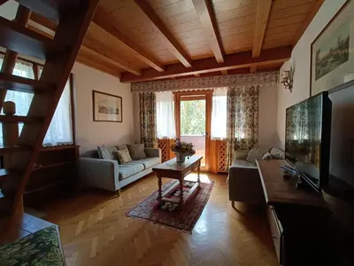 a living room with a couch and a tv at Luxury Panoramic 3BR Apt 2min to Centre 5min to Lifts in Cortina dʼAmpezzo