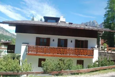 a house with a balcony on the side of it at Luxury Panoramic 3BR Apt 2min to Centre 5min to Lifts in Cortina dʼAmpezzo