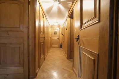 a hallway with wooden walls and a ceiling with a hallwayngthngthngthngthngth at Luxury Panoramic 3BR Apt 2min to Centre 5min to Lifts in Cortina dʼAmpezzo
