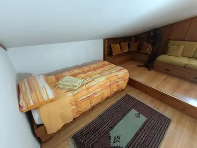an overhead view of a bedroom with a bed and a couch at Luxury Panoramic 3BR Apt 2min to Centre 5min to Lifts in Cortina dʼAmpezzo
