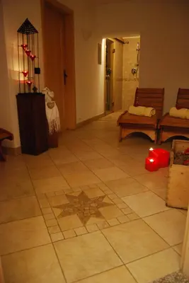 a living room with a tile floor with a star on it at Residence Ciasa Alpe in Vigo di Fassa