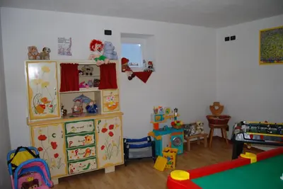 a childs room with toys and a play area at Residence Ciasa Alpe in Vigo di Fassa