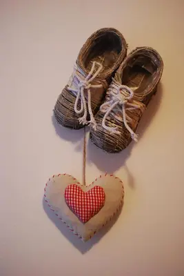 a pair of shoes with a heart shaped cookie at Residence Ciasa Alpe in Vigo di Fassa