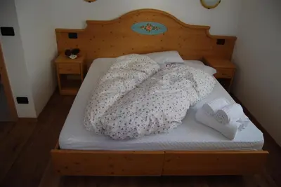 a bed with two pillows on top of it at Residence Ciasa Alpe in Vigo di Fassa