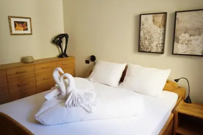 two swans are sitting on a bed with towels at Apartment Cascada - Alpstay in Parcines