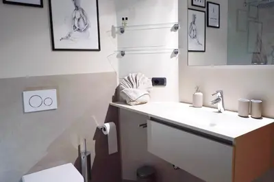 a bathroom with a sink and a mirror and a toilet at Apartment Cascada - Alpstay in Parcines