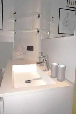 a white bathroom with a sink and a mirror at Apartment Cascada - Alpstay in Parcines