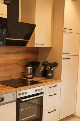 a kitchen with white cabinets and a stove top oven at Residence Klementhof in Naz-Sciaves