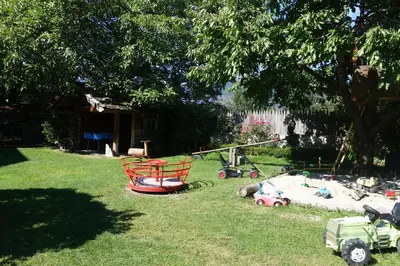 a yard with a playground with toys in the grass at Residence Klementhof in Naz-Sciaves