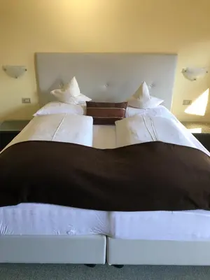 a large black and white bed in a room at Hotel & Appartement Valtnaungut in Cermes