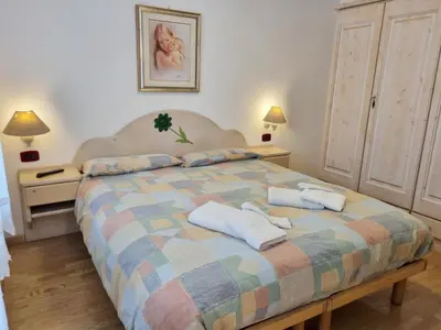 a bedroom with a bed with two towels on it at Ciapià in Campitello di Fassa