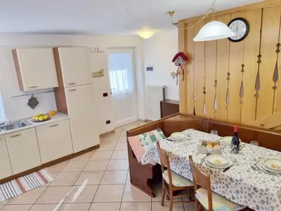 a kitchen and dining room with a table and chairs at Ciapià in Campitello di Fassa