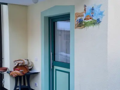 a door in a room with a sign on the wall at Ciapià in Campitello di Fassa