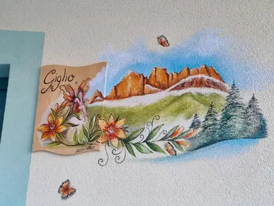 a painting of a mountain with insects on a wall at Ciapià in Campitello di Fassa