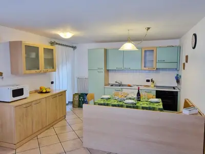 a kitchen with blue cabinets and a counter top at Ciapià in Campitello di Fassa