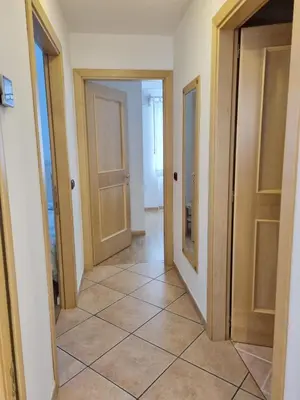 a hallway with two doors and a tile floor at Ciapià in Campitello di Fassa