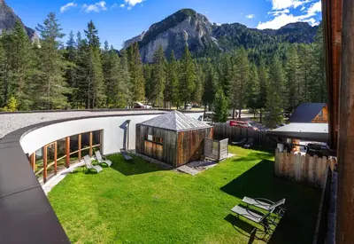 an image of a backyard with a house at Camping Sass Dlacia in San Cassiano