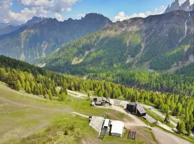 an aerial view of a farm in the mountains at La Casa Degli Orsi - presso Sussy Residence in Falcade
