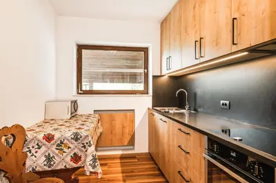a kitchen with a table and a counter top at Chalet Scherlin in Ortisei