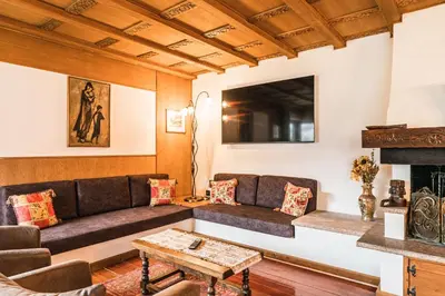 a living room with a couch and a fireplace at Chalet Scherlin in Ortisei