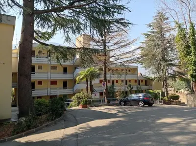 a car parked in a parking lot in front of a building at chez Chany in Merano