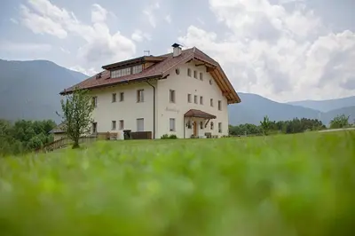 a bedroom with a large bed and a television at Moarberg in Brunico