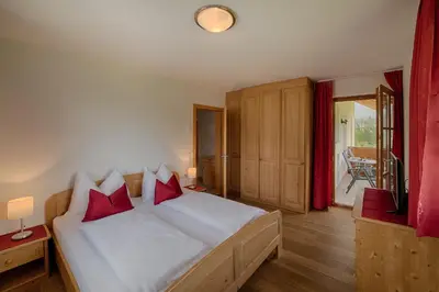 a hotel room with two beds and a window at Moarberg in Brunico