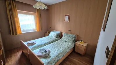 a small bedroom with a bed and a window at Appartment Deville with Garden in Moena