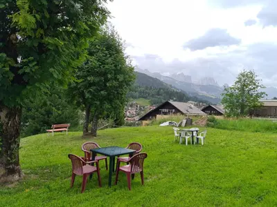 a group of chairs around a table in a field at Appartment Deville with Garden in Moena